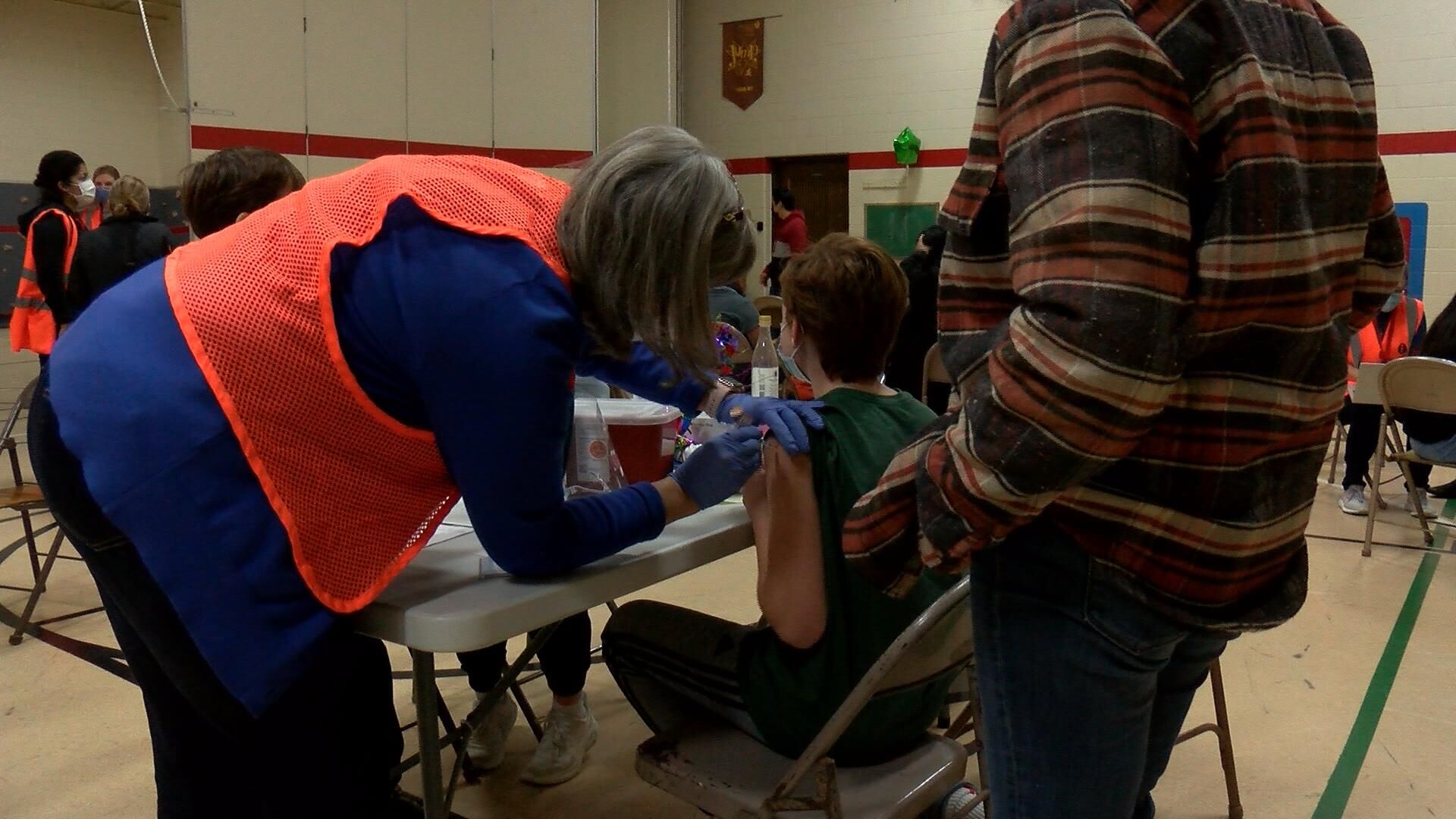 To stem outbreaks post holidays parents get booster shots and kids vaccinated